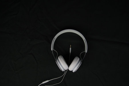 white studio headphones for recording podcast on black backgrounds. objectの写真素材