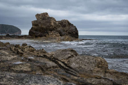 beach with rocks on the coast of the town of Morarira in the province of Alicante, Valencian community, Spain. viewの写真素材