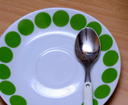 Spoon on a green plateの写真素材