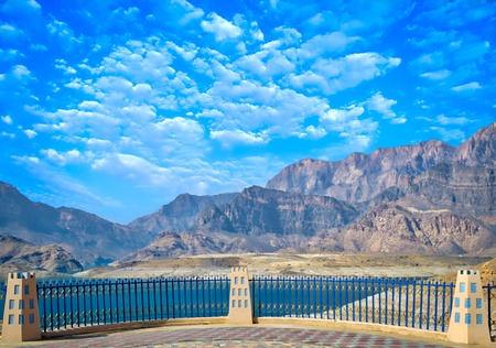 Viewpoint in the garden to see the vast landscape of mountains, water and a clear blue sky.の写真素材
