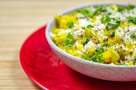North Indian Food Poha in a bowl on a red plate