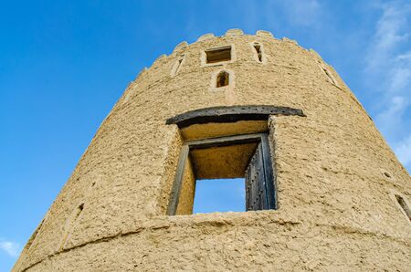 Old Watchtower of an old fortress rising up to the sky - shot from below. From Muscat, Oman.の写真素材