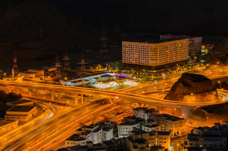 Motion trails and traffic of an illuminated Muscat city in the evening.の写真素材