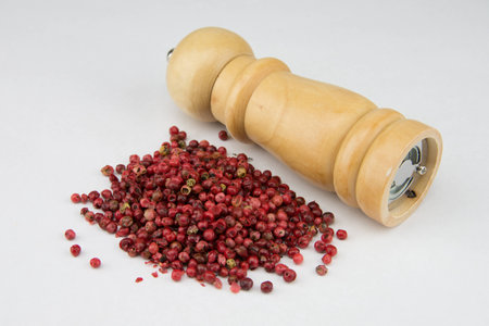 Red pepper with grinder on white backgroundの写真素材