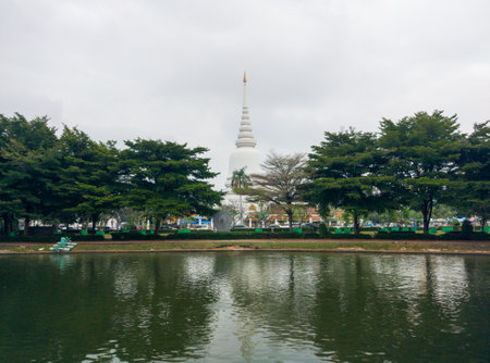 The white pagoda is located by the water.の写真素材