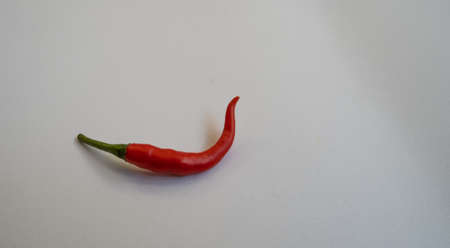 Bright red peppers have a beautiful bend.の写真素材
