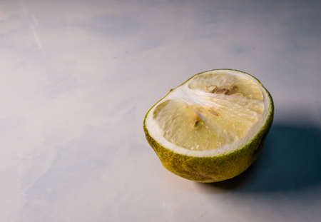 Half a raw lime has been on tile, for several days.の写真素材