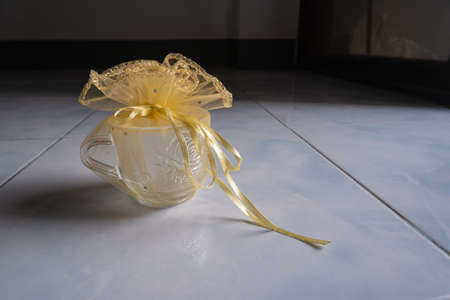 Clear glass wrapped in cloth in a beautiful flower shape, suitable as souvenir.の写真素材