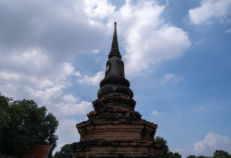 Old chedi in Ayutthaya, with sky and clouds, behindの写真素材