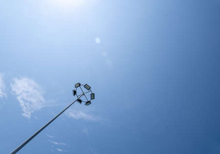 High pole spotlight, with many bulbs, shooting in bright sunlight.