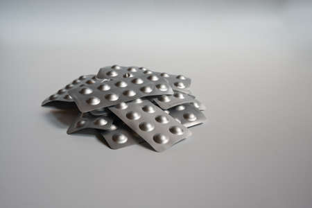Many pills were placed together, on a white background, which were used to treat diseases.