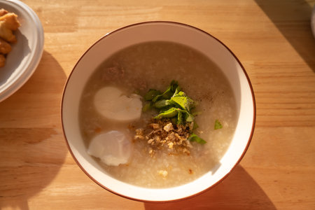 Hot porridge, put in a cup, set in the morning sun.の写真素材