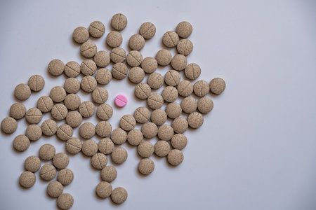 One pink pill was placed with senna herbal medicine, white backの写真素材