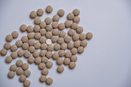 The senna herbal pill, was placed around a white pill, with a line in the middle.の写真素材
