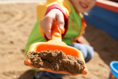 Child with shovel at playground