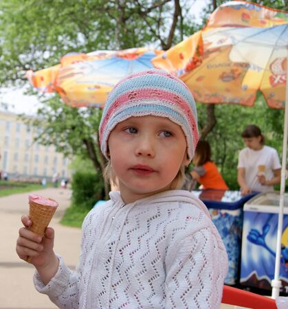 Girl eats an ice cream outdoorのeditorial素材