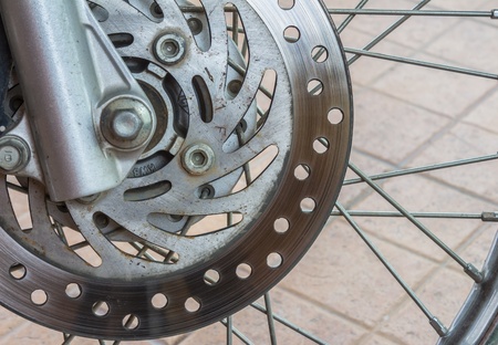 Detail of the front wheel of a motorcycle with disc brakeの写真素材