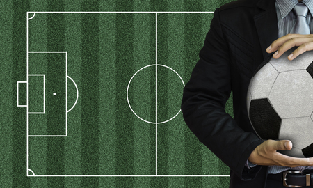 Businessman holding the ball on a black .の写真素材