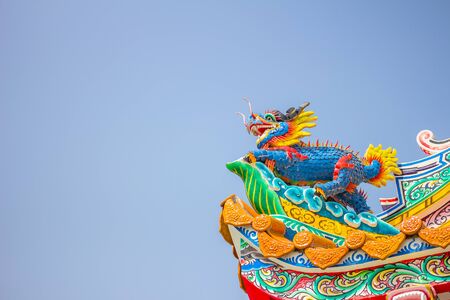 Chinese style dragon statue with blue sky.の写真素材