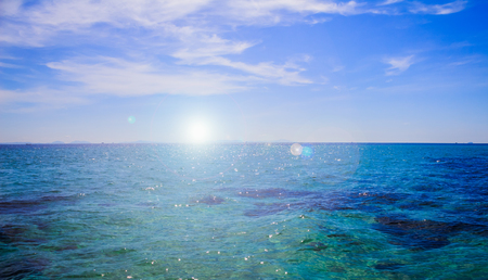 Blue landscape background sea surface backlit morning lightの写真素材