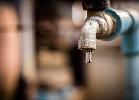 old rusty tap leaking water