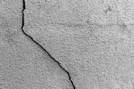 Grunge concrete cement wall with crack in industrial building