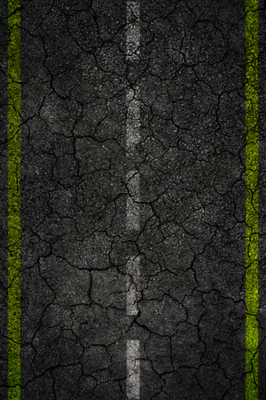 Crack road texture with two yellow stripes and dashed white stripeの写真素材