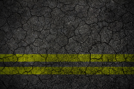 Crack asphalt Road Texture With Yellow Stripの写真素材