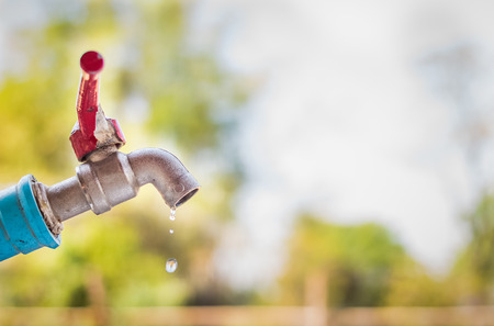 old rusty tap leaking waterの写真素材