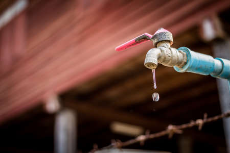 old rusty tap leaking waterの写真素材