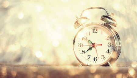Vintage background with retro alarm clock on table
