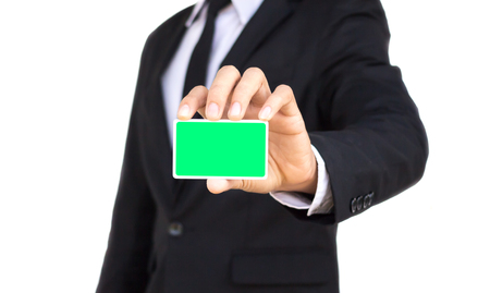 businessman showing empty card green screen on white backgroundの写真素材