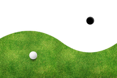 White golf ball on green grass and white backgroundの写真素材