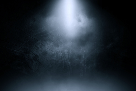 Blue spotlight smoke studio old black wood background.の写真素材