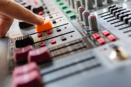 Hand adjusting audio mixer soundの写真素材