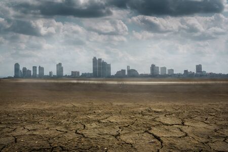 A city looks over a cracked earth landscape