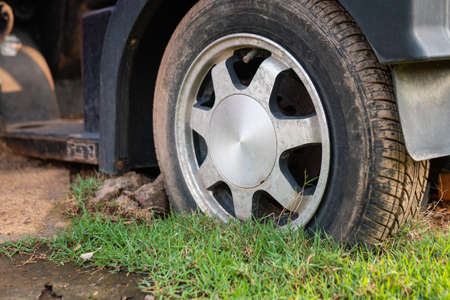 Flat car tires abandoned on the lawnの写真素材