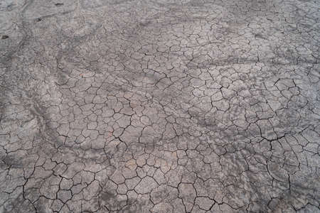Ground dry cracked soil texture background.