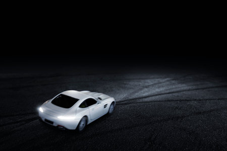 The white sports car that focuses on the back, runs on a road with at night.の写真素材