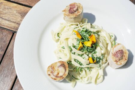 Pasta dish on a restaurant tableの写真素材