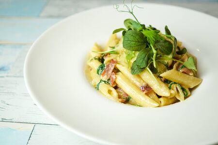 Pasta dish on a restaurant tableの写真素材