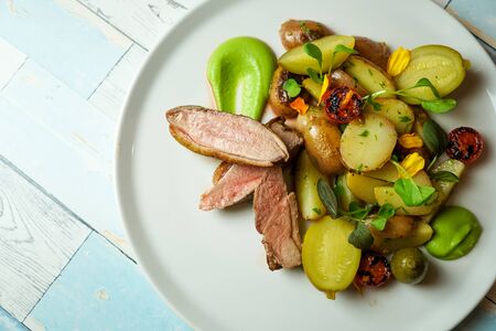 Pork dish on a restaurant tableの写真素材