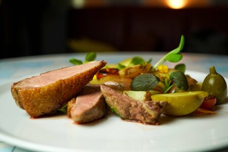 Pork dish on a restaurant tableの写真素材