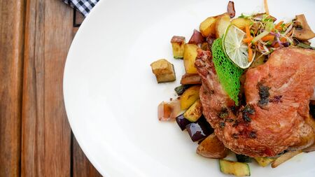 Pork dish on a restaurant tableの写真素材