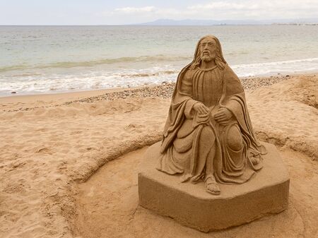 Sand statue representing a men on the Pacific ocean beach in Puertovallarta, Mexicoの写真素材
