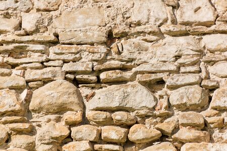 Medieval stone wall on suset light (background)の写真素材