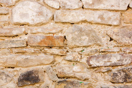 Medieval stone wall on suset light (background)の写真素材