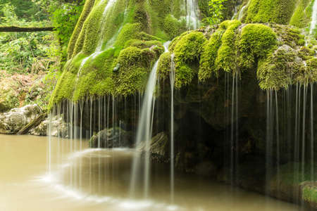 Wild natural waterfall in a deep mountain forestの写真素材