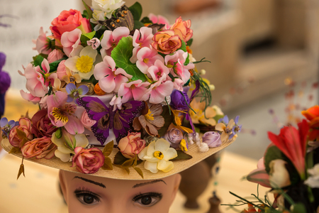 Hat with natural and artificial spring flowersの写真素材
