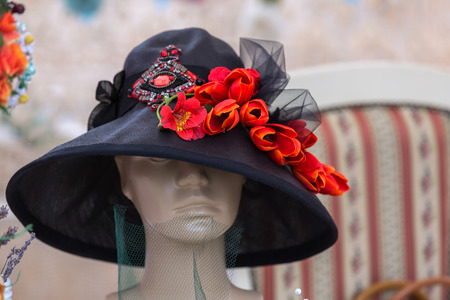Hat with natural and artificial spring flowersの写真素材